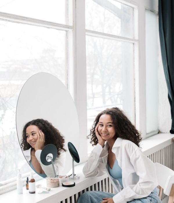 Woman feeling energized and happy in a bright, clean room.